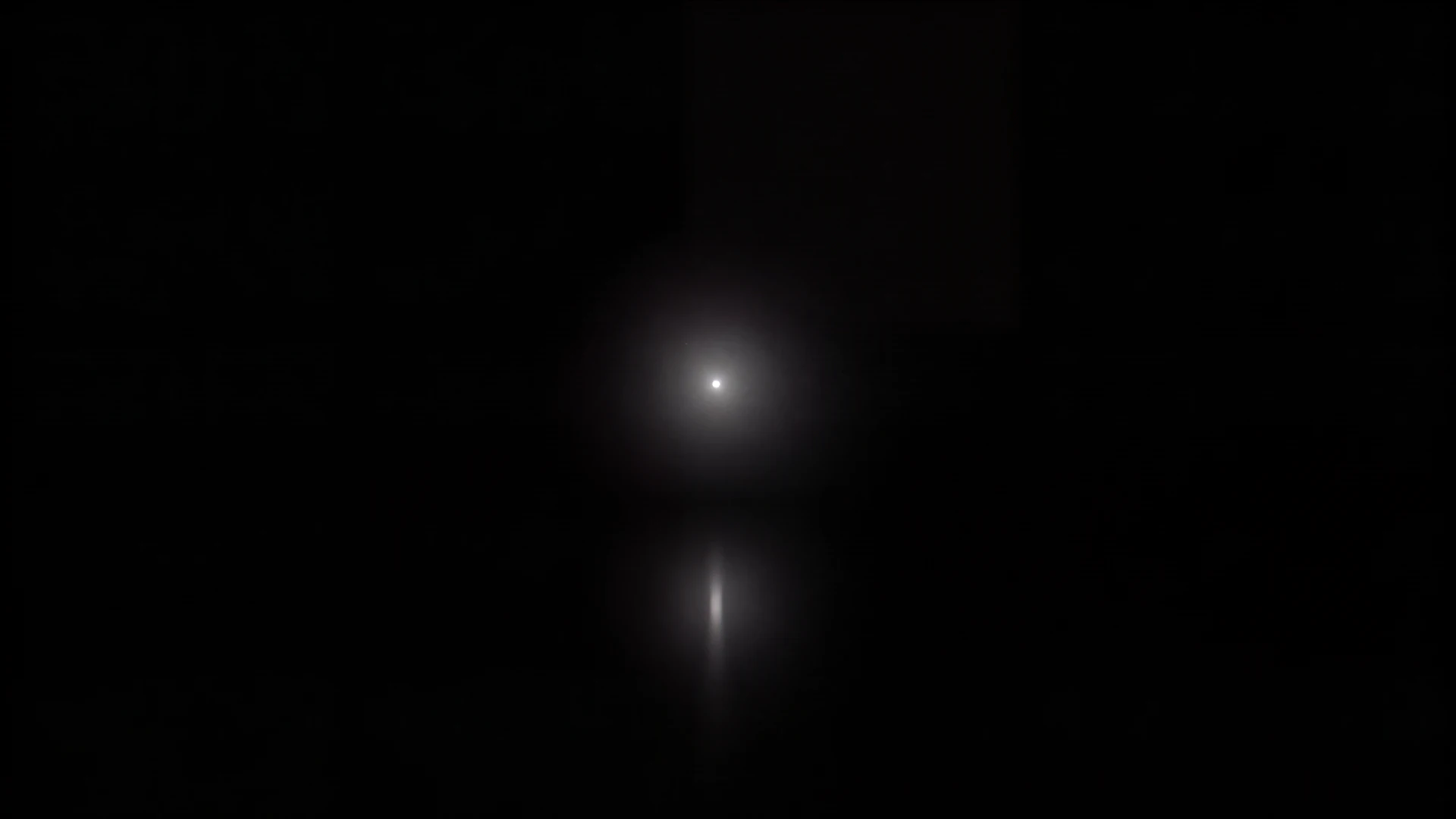 A single point of light in darkness
